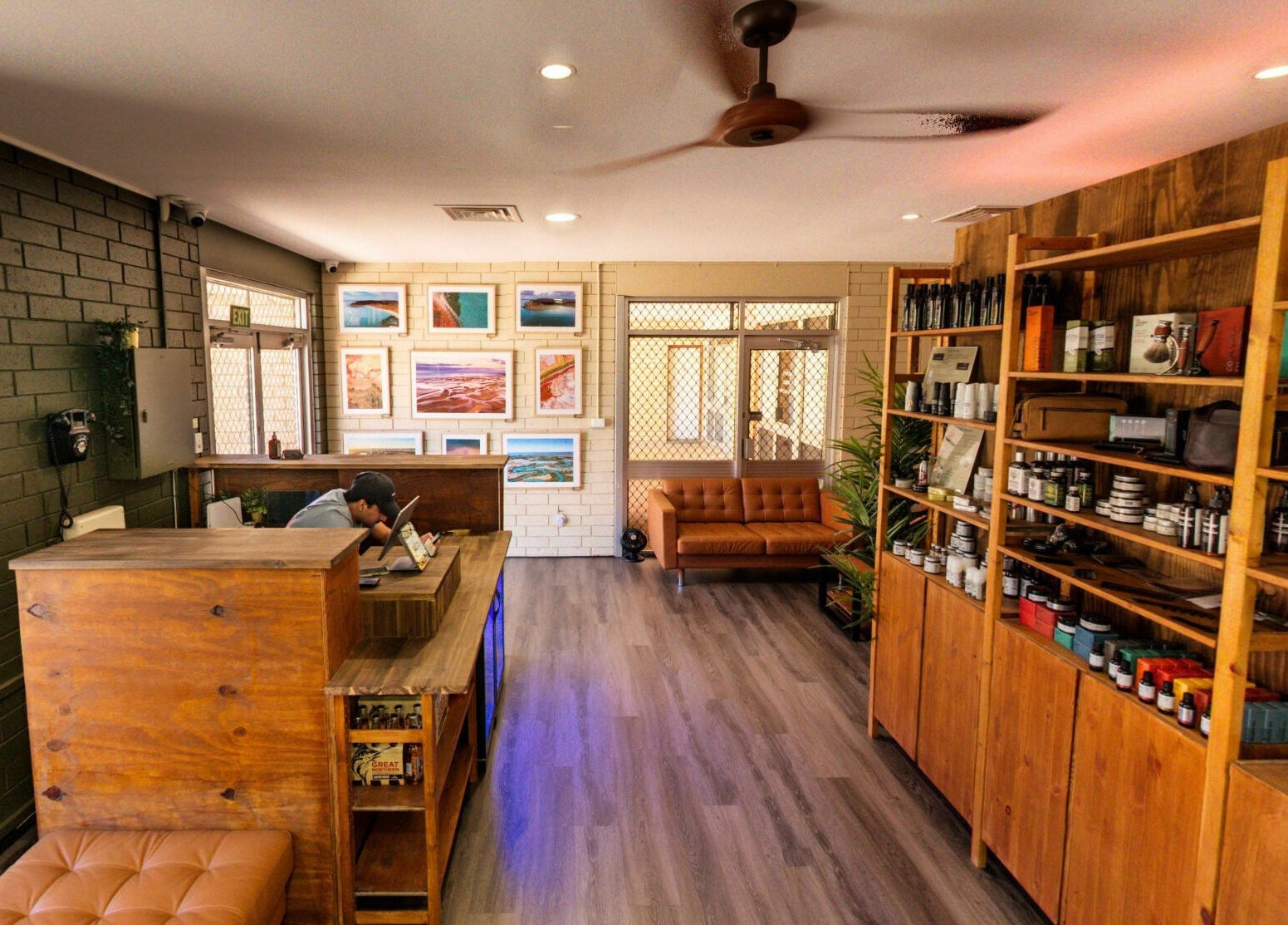 Interior of The Big Beard Cartel Barbershop at Karratha, Western Australia, AU, showcasing wood shelves and seating.