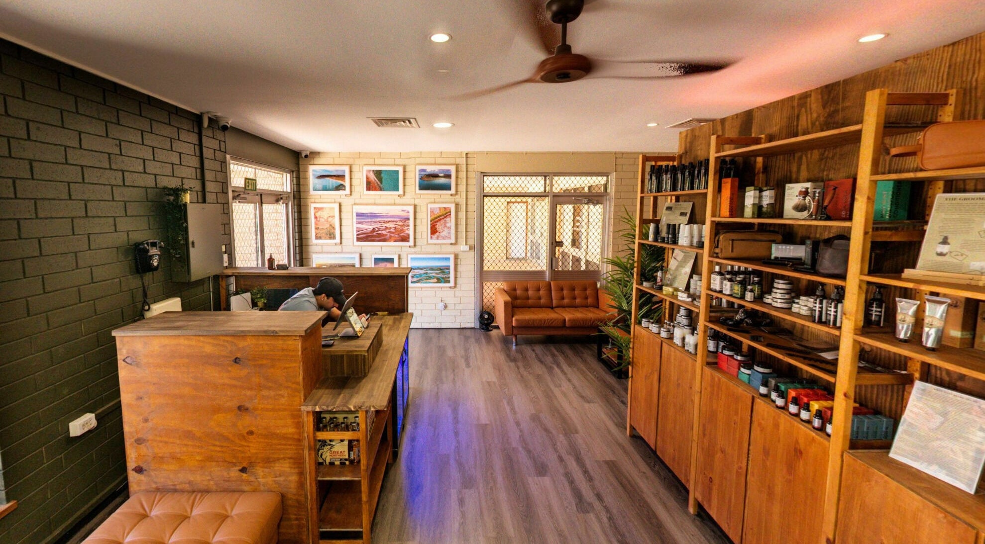 Interior of The Big Beard Cartel Barbershop at Karratha, Western Australia, AU, showcasing wood shelves and seating.