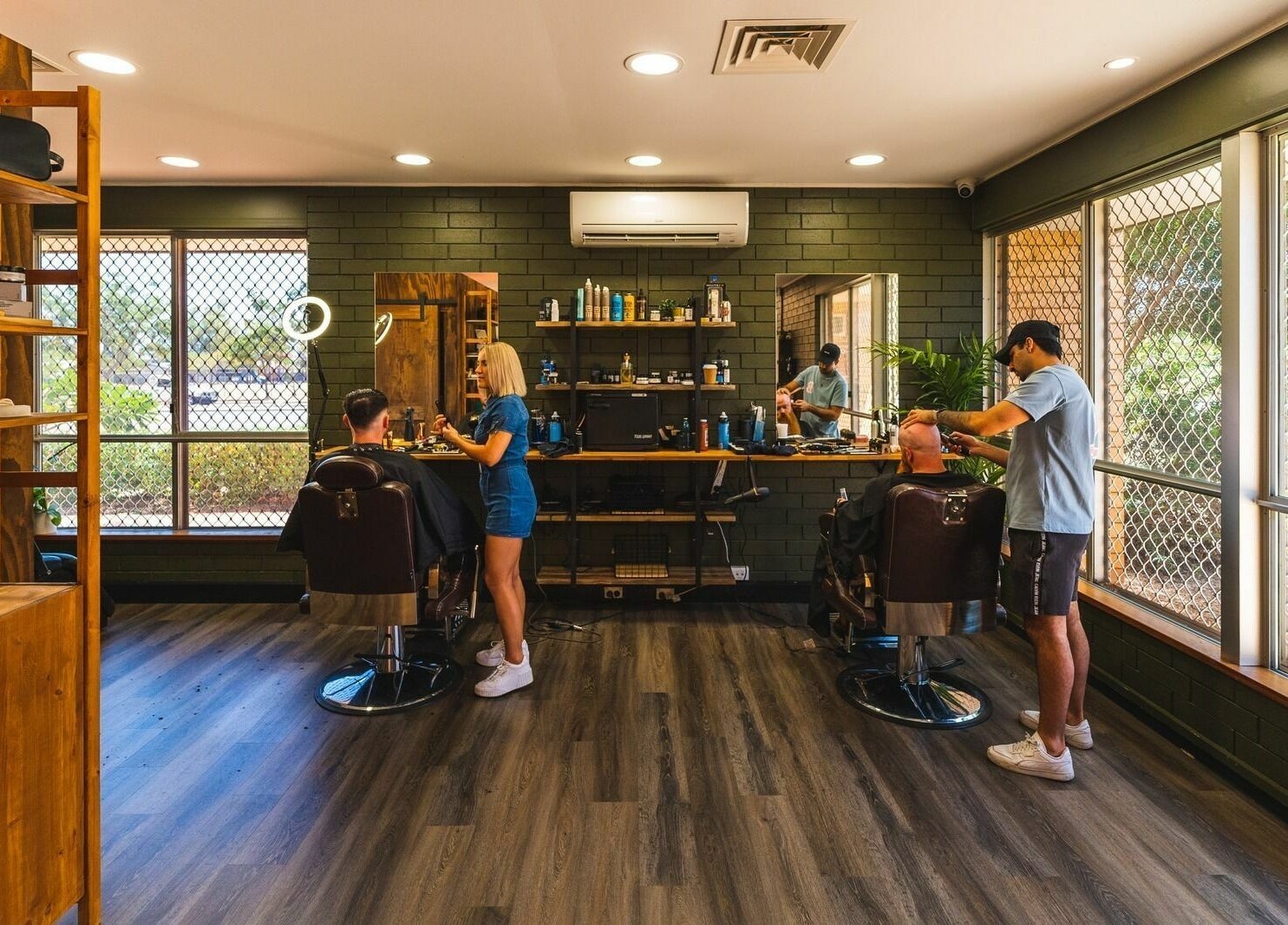 Interior of The Big Beard Cartel Barbershop in Karratha, Western Australia, AU showing stylists at work.