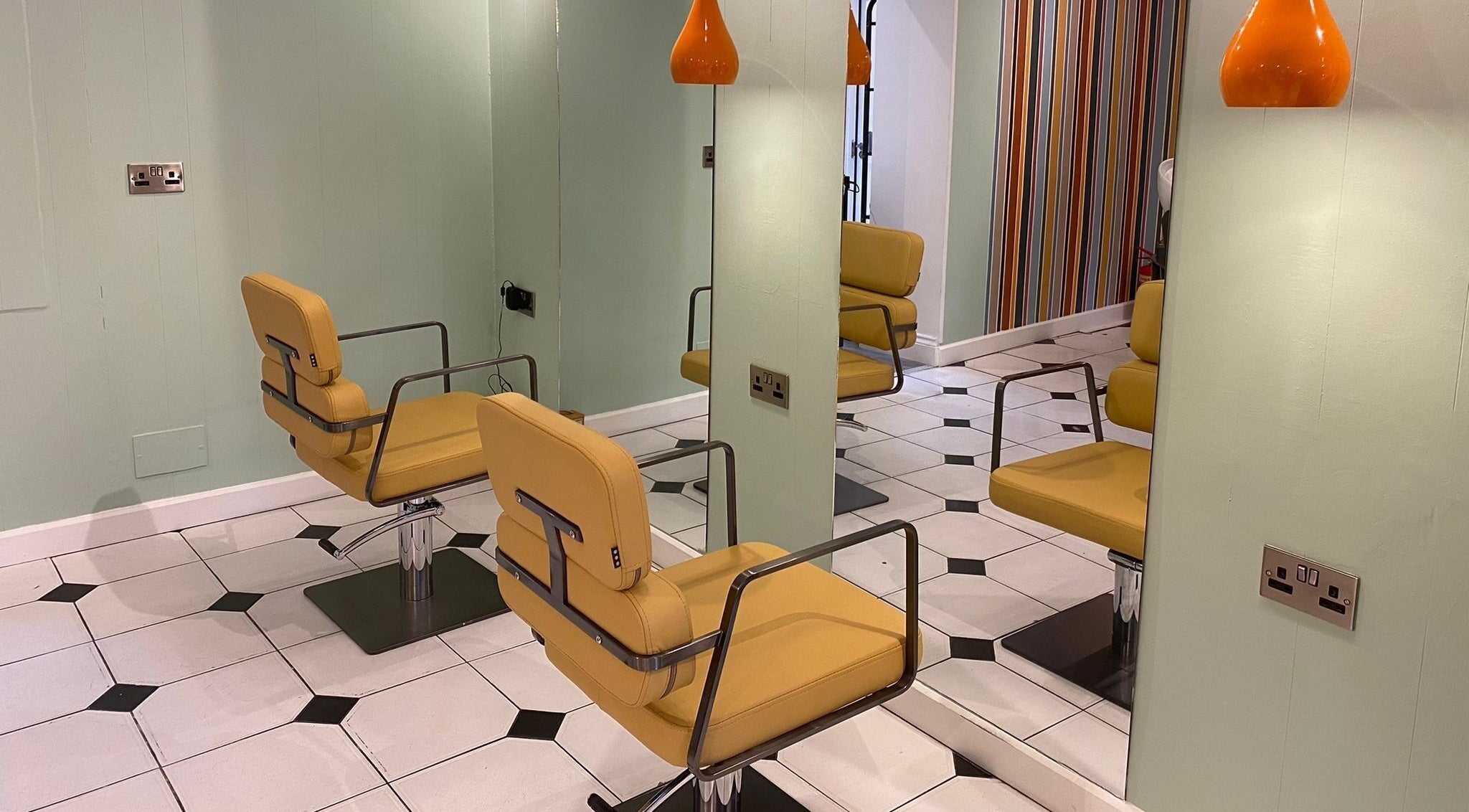 Chic salon chairs at Alberto's Hair, a top beauty spot in London, England, GB, with unique decor.