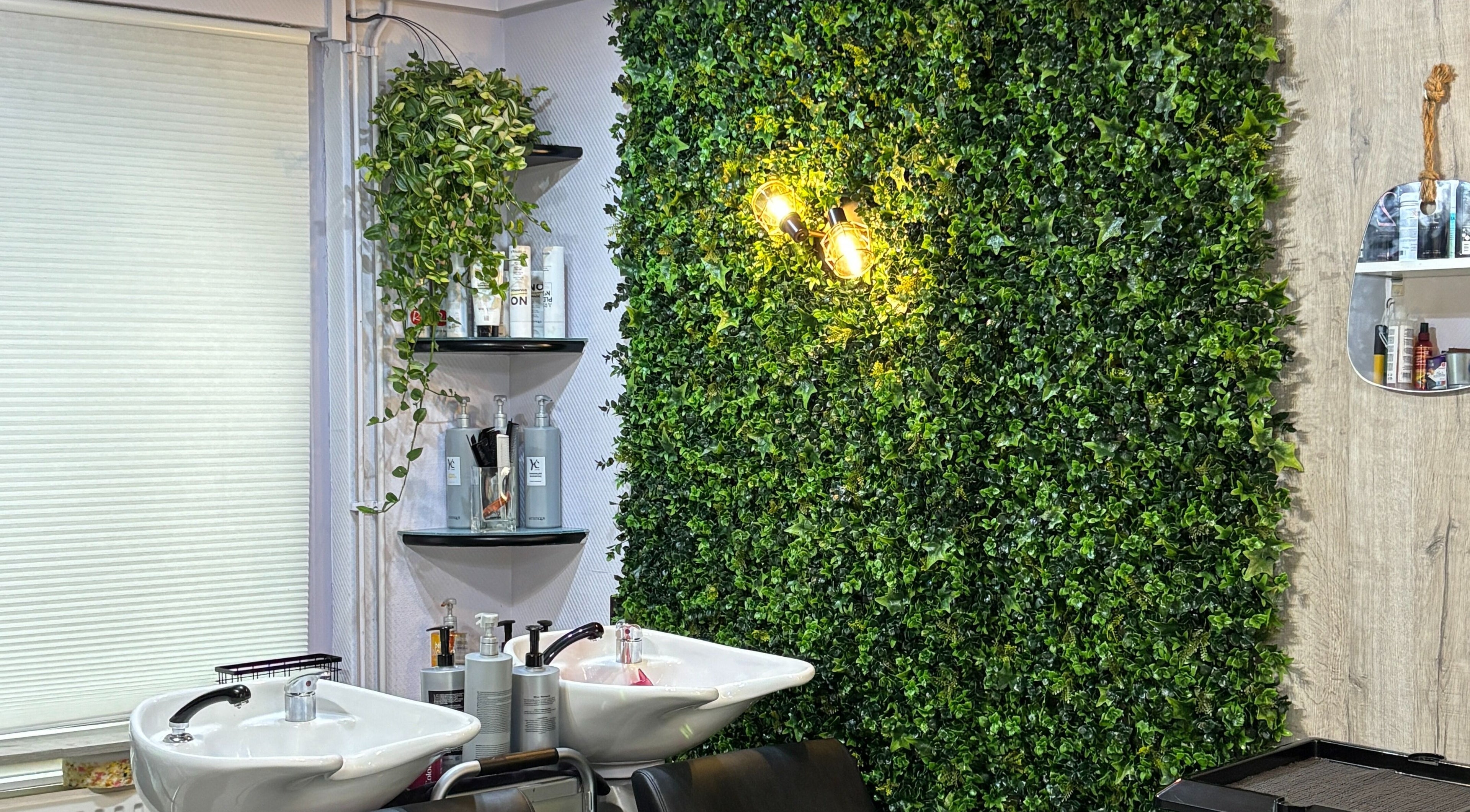 Relaxing salon space at Anima Beauty, Amsterdam, Noord-Holland, NL, with lush greenery and shampoo station.