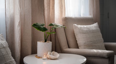 Cozy chair and plant setting at House of Sol, Christchurch, New Zealand, NZ, radiating calm elegance.