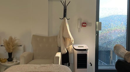 Relaxing cozy corner at Millzbeauty, High Wycombe, England, GB, featuring a plush chair and decor.