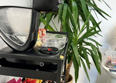 Cozy coffee station at Millzbeauty, High Wycombe, England, GB, with lush plants and snacks.