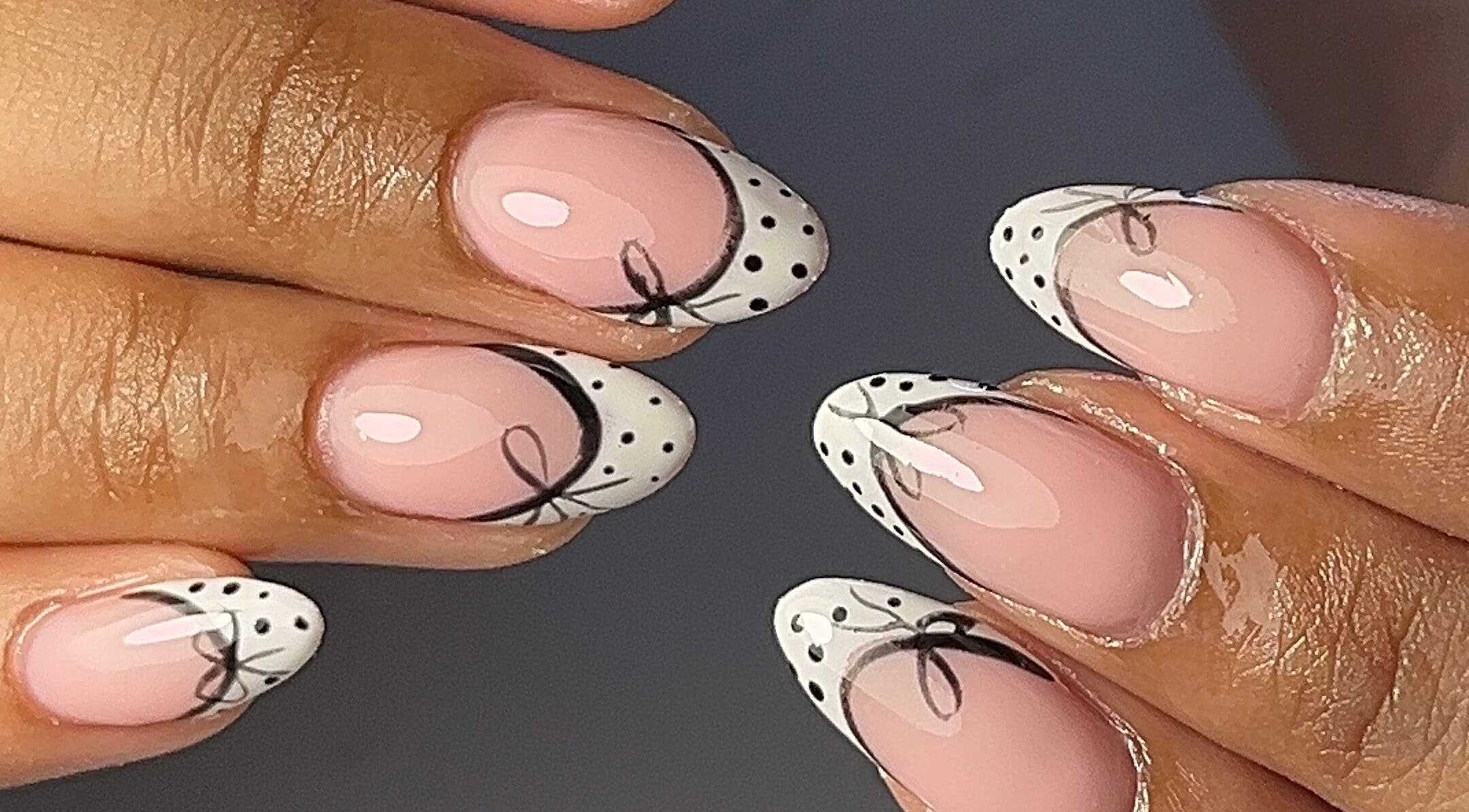 Elegant nail art with dots and bows at The Nail Goddess, Cape Town, Western Cape, ZA.