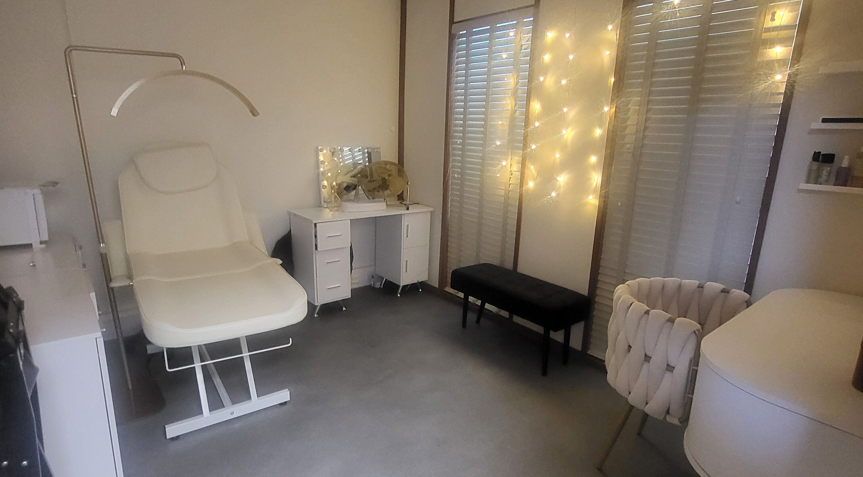 Relaxing therapy room at Butterfly Beauty & Holistic Therapies in Corsham, England, GB with soft lighting and comfy chairs.