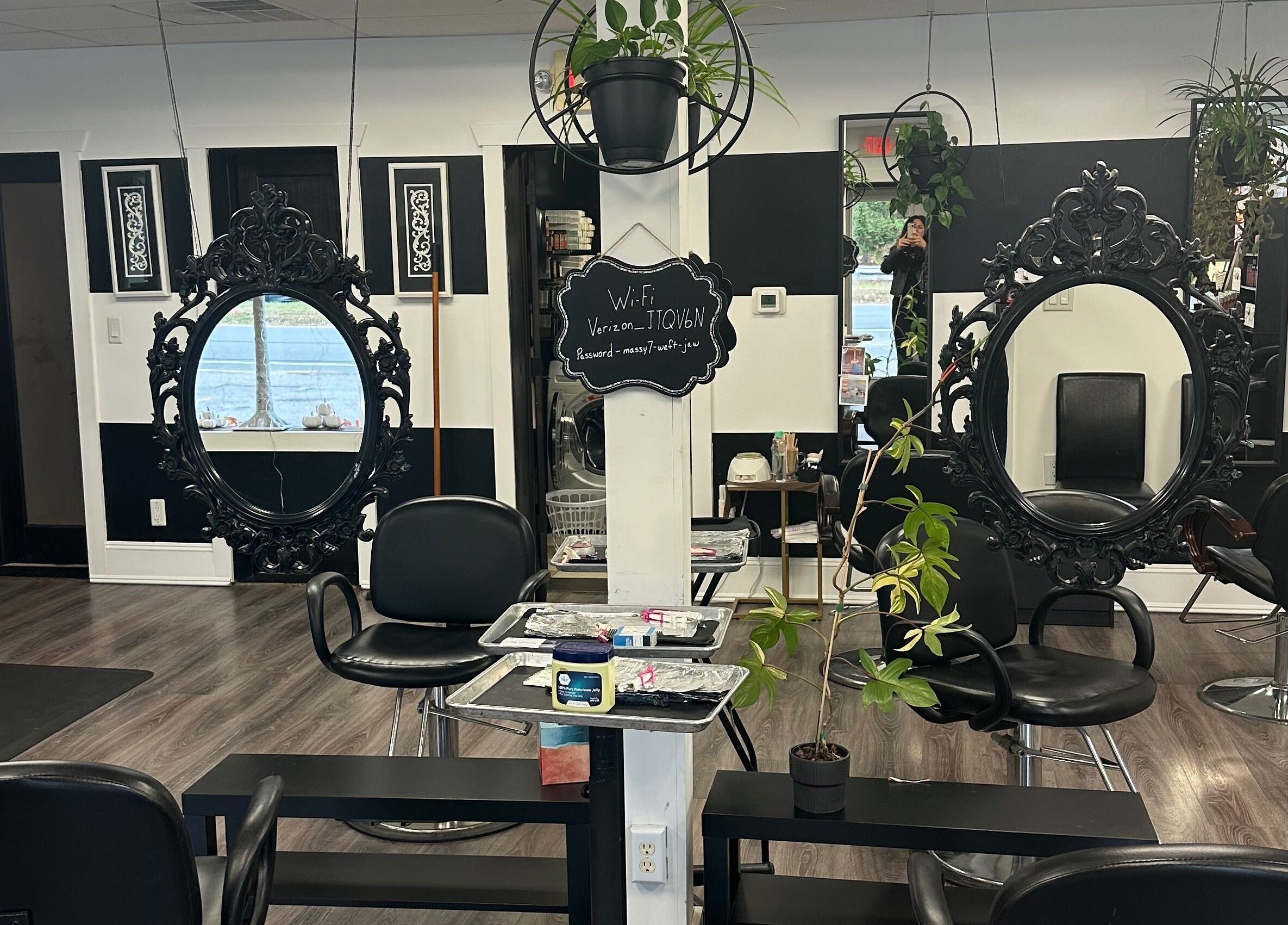 Spacious interior of Salon Soiree in Denville, New Jersey, US featuring ornate black mirrors and sleek chairs.