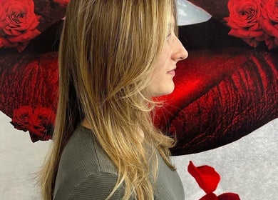 Elegant hairstyle captured at Salon Soiree in Denville, New Jersey, US with a rose backdrop.