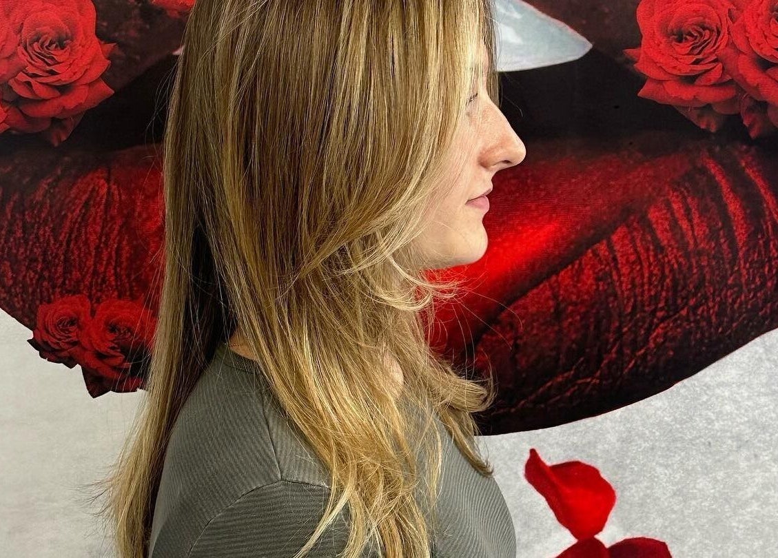 Elegant hairstyle captured at Salon Soiree in Denville, New Jersey, US with a rose backdrop.