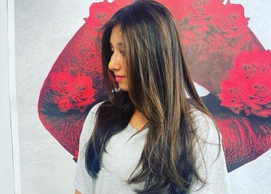 Elegant hair styling at Salon Soiree, Denville, New Jersey, US with a rose-themed background.