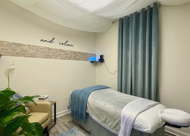 Tranquil massage room at Black Oasis Luxury Mind & Body, Conyers, Georgia, US with a cozy treatment bed.