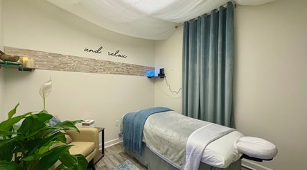 Tranquil massage room at Black Oasis Luxury Mind & Body, Conyers, Georgia, US with a cozy treatment bed.