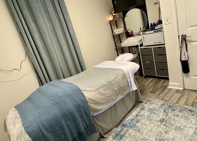 Relaxing treatment room at Black Oasis Luxury Mind & Body, Conyers, Georgia, US, featuring a cozy massage bed.