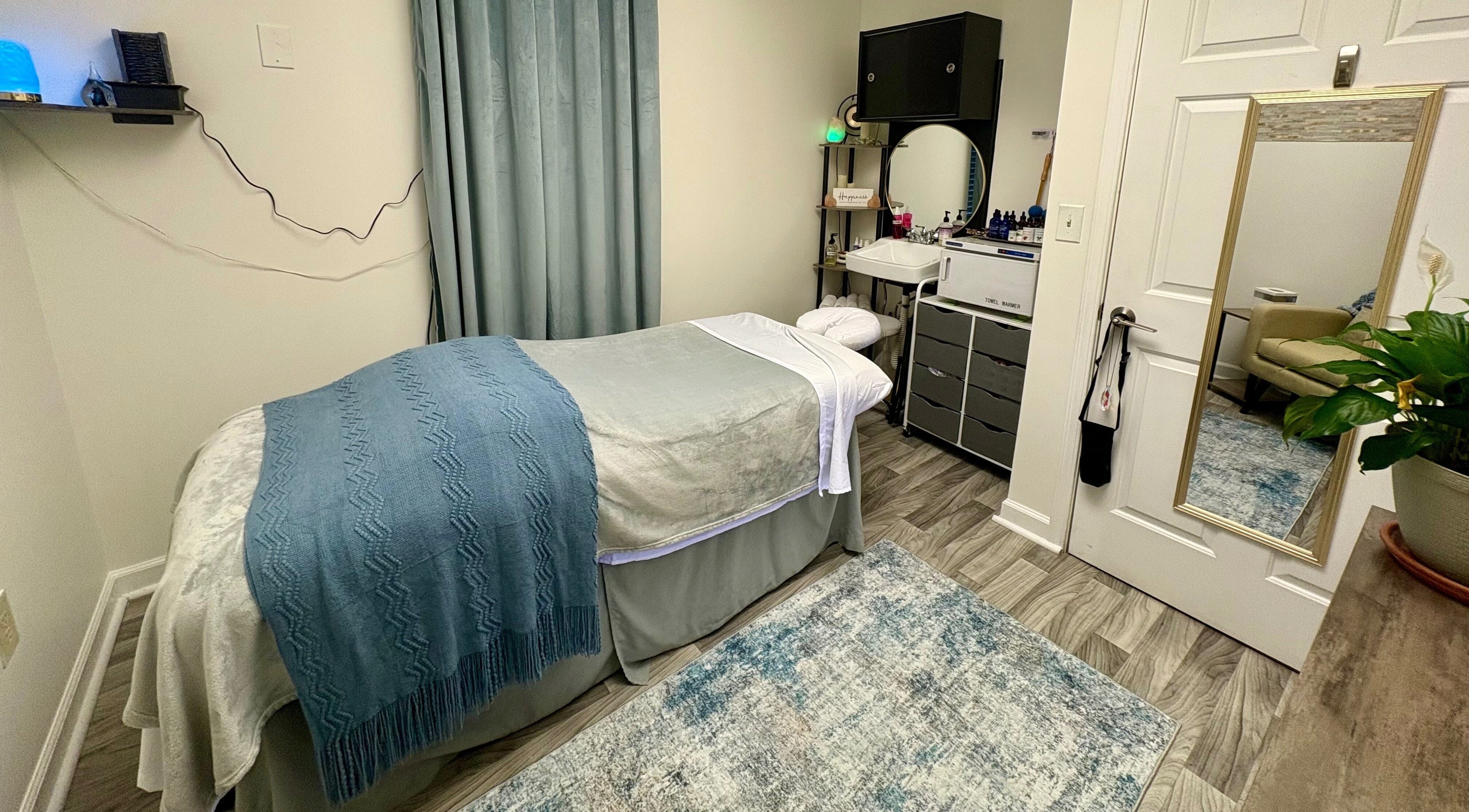 Relaxing spa room at Black Oasis Luxury Mind & Body in Conyers, Georgia, US with massage bed and elegant decor.