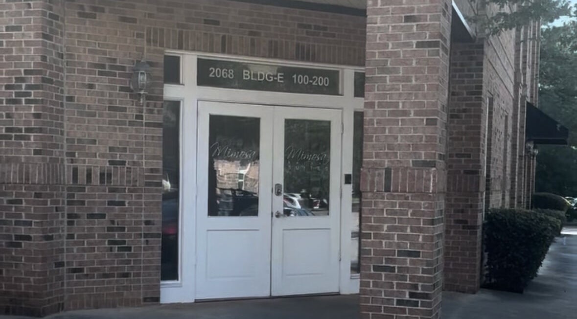 Front entrance of Black Oasis Luxury Mind & Body, Conyers, Georgia, US, with brick exterior.