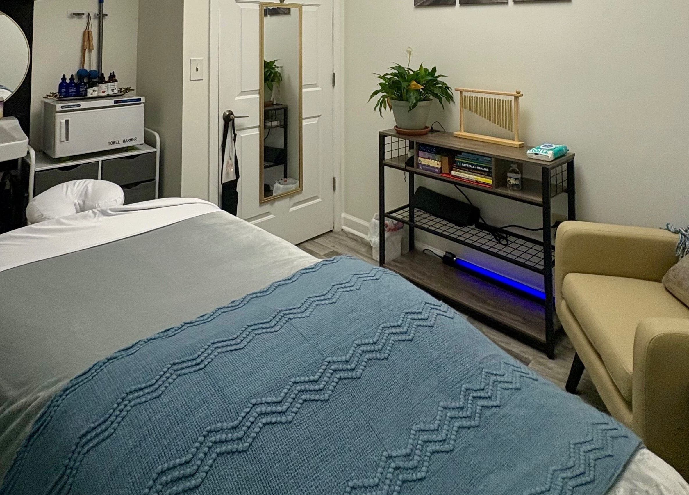 Luxurious massage room at Black Oasis Luxury Mind & Body, Conyers, Georgia, US, featuring cozy bed and decor.