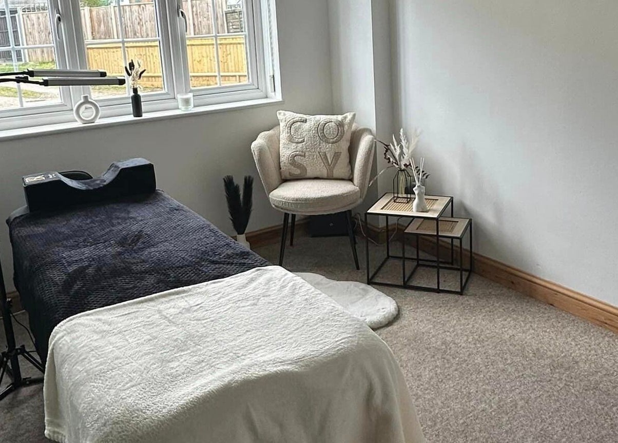 Cozy treatment room at BeautyRush in Andover, England, GB with a comfortable chair and massage table.