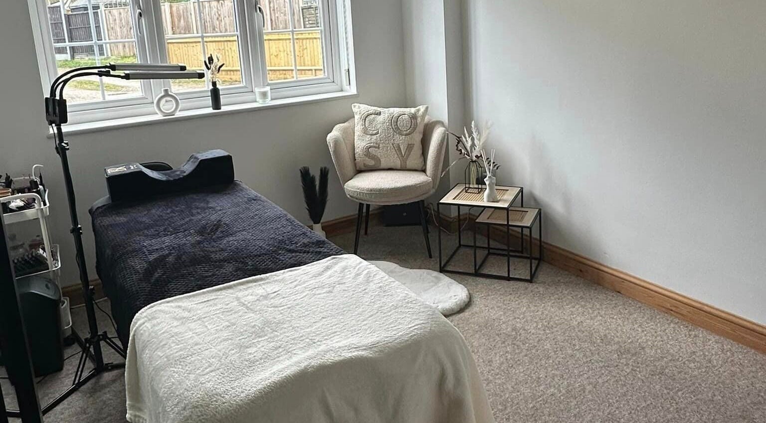 Cozy treatment room at BeautyRush in Andover, England, GB with a comfortable chair and massage table.