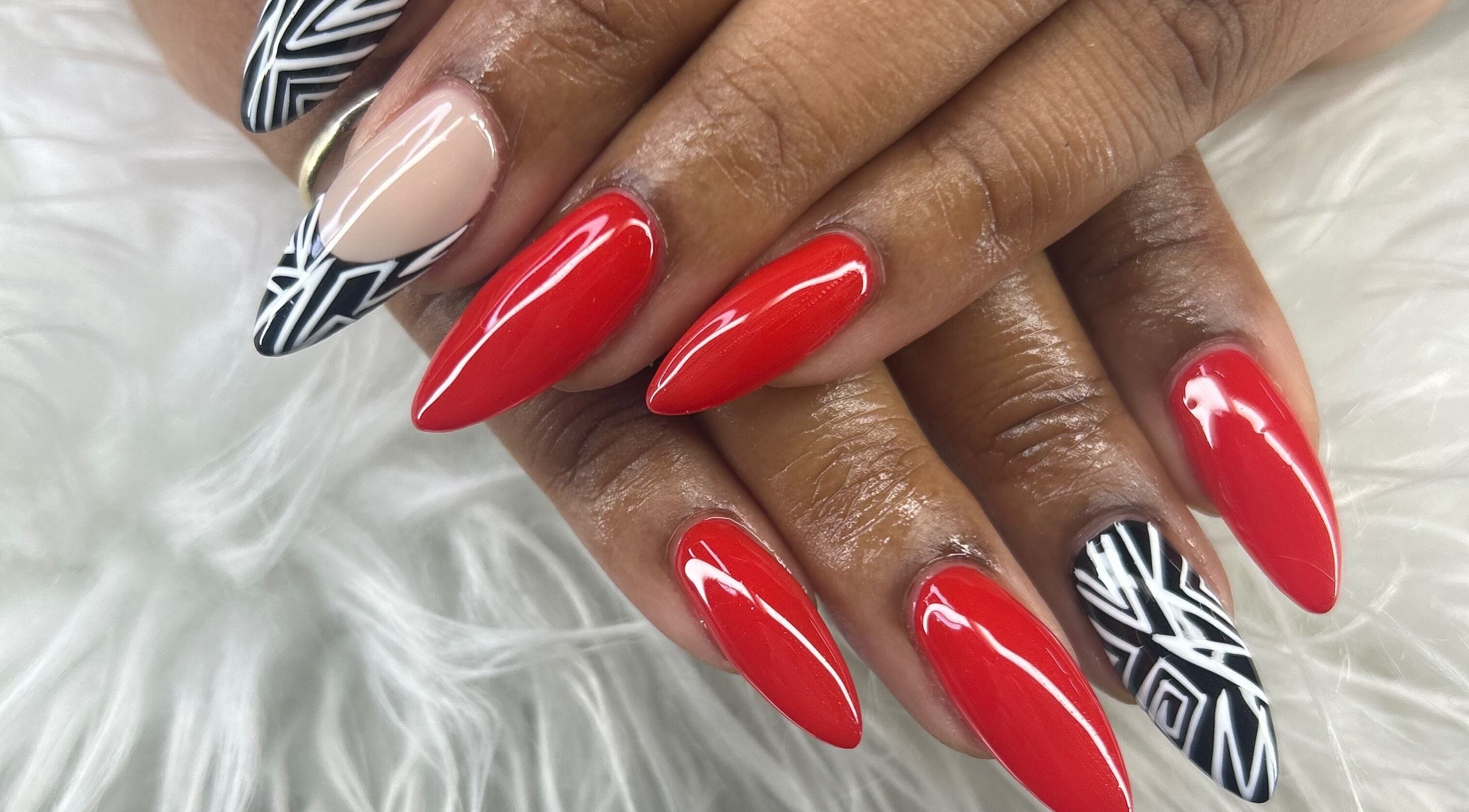 Stylish red and black nail art at Nubian Nails, Morrow, Georgia, US, showcasing elegant manicure design.