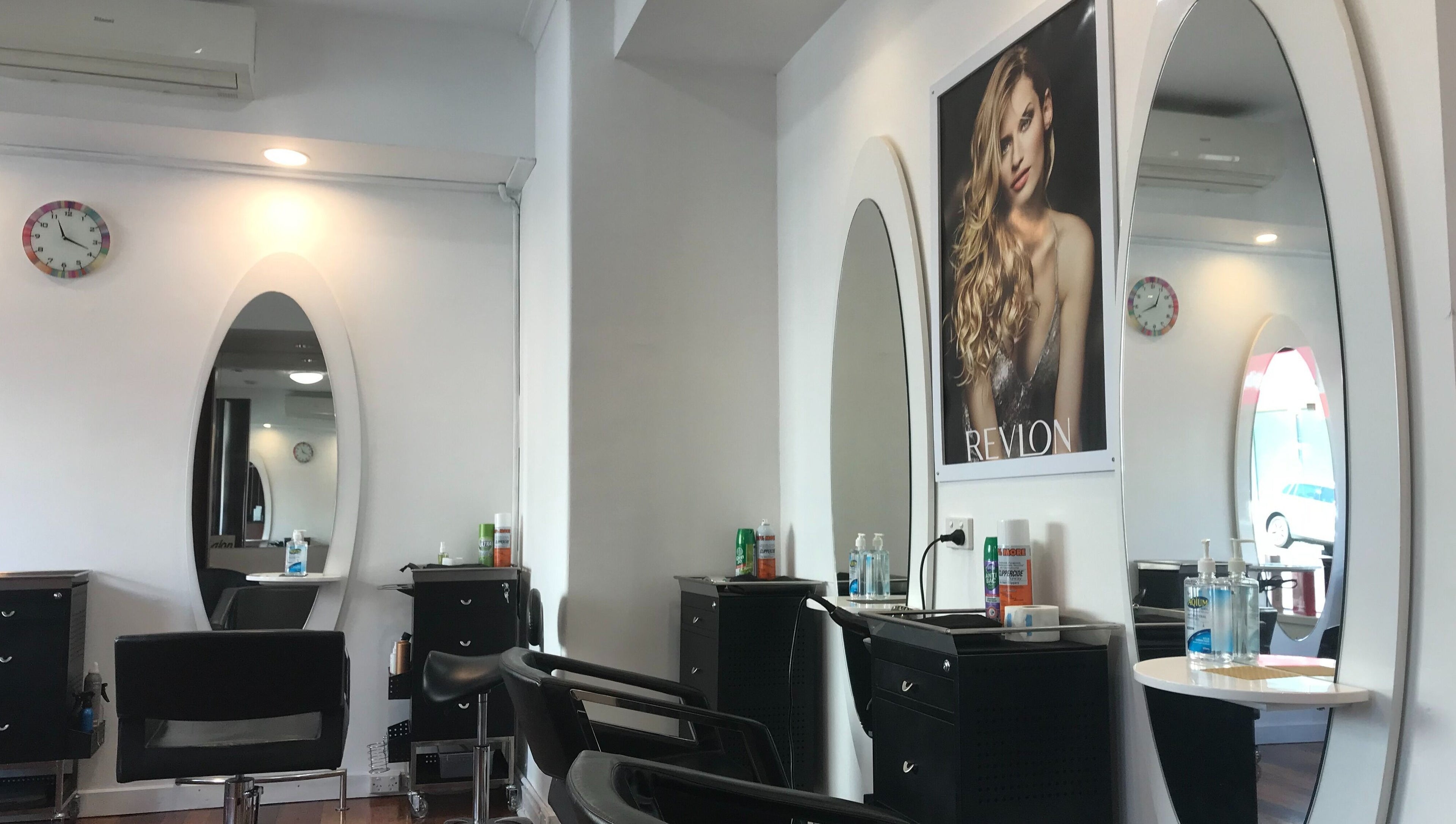 Stylish interior of Hair Hut Camberwell/Hair By Sha, showcasing modern styling stations in Melbourne, Victoria, AU.