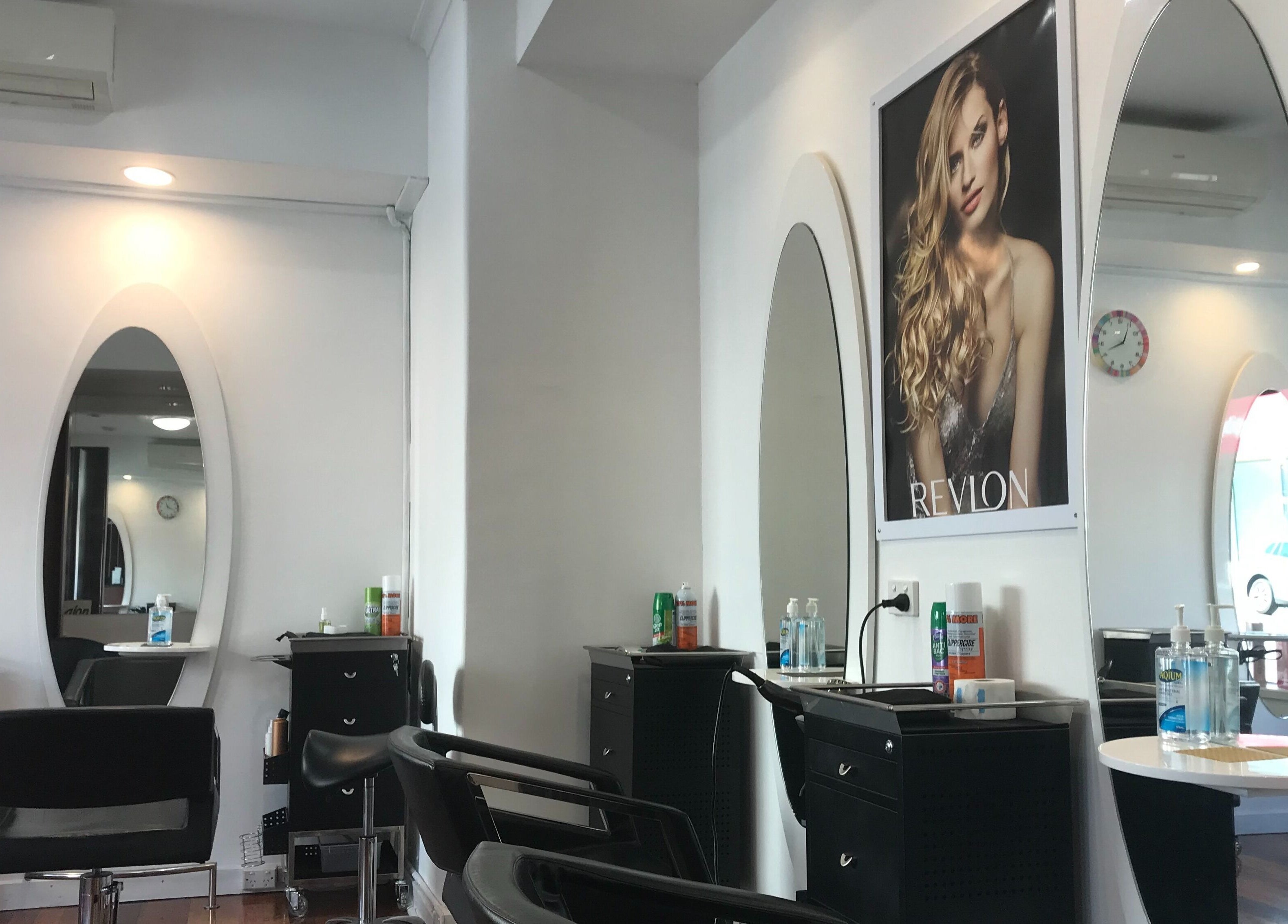 Stylish interior of Hair Hut Camberwell/Hair By Sha, showcasing modern styling stations in Melbourne, Victoria, AU.