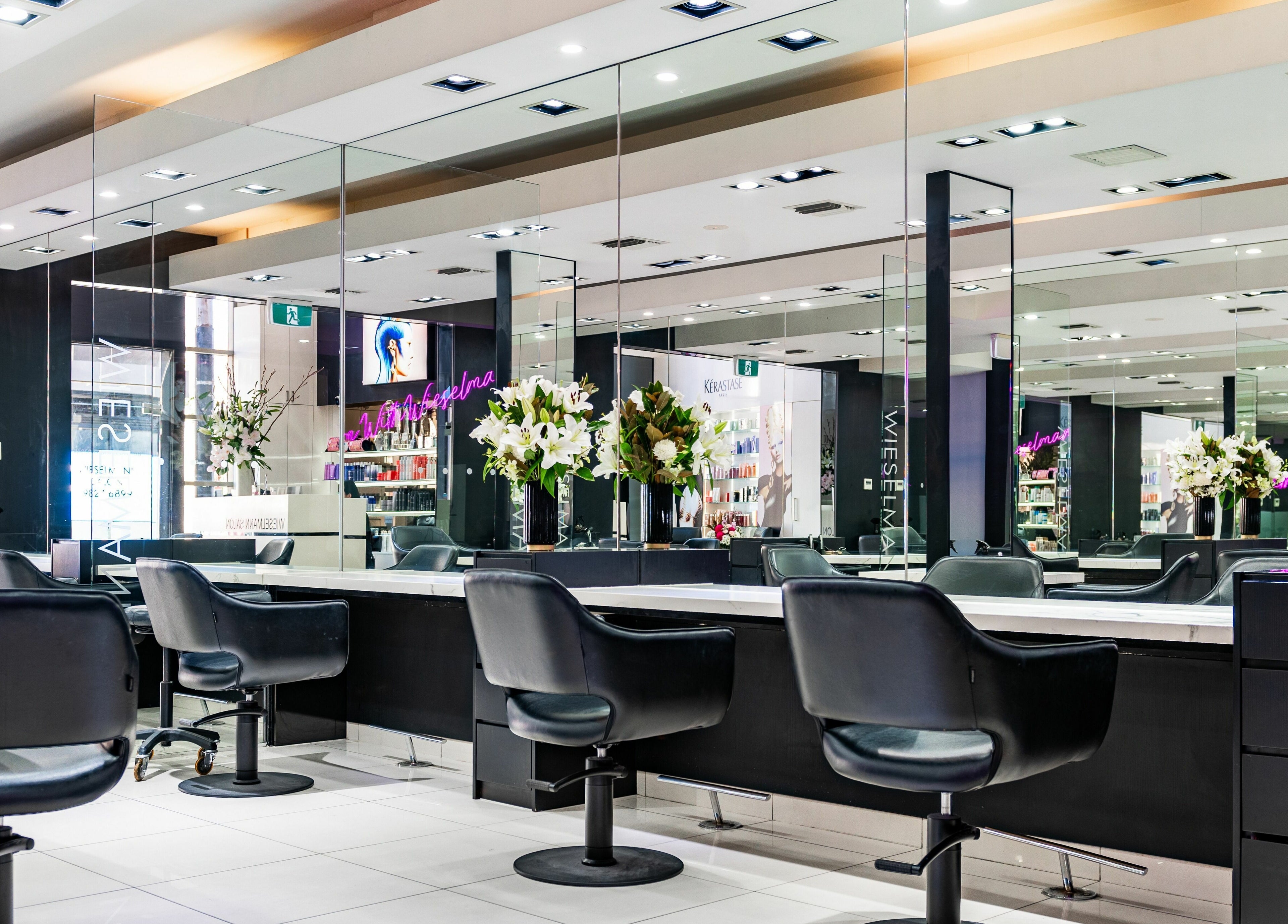 Wieselmann Salon in South Yarra, VIC, AU features luxurious styling chairs and mirrors in a modern setting.