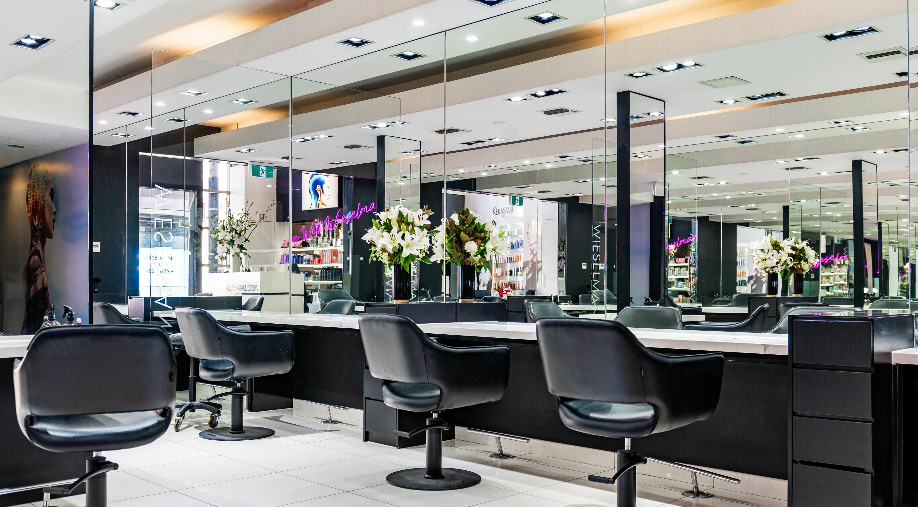 Wieselmann Salon in South Yarra, VIC, AU features luxurious styling chairs and mirrors in a modern setting.
