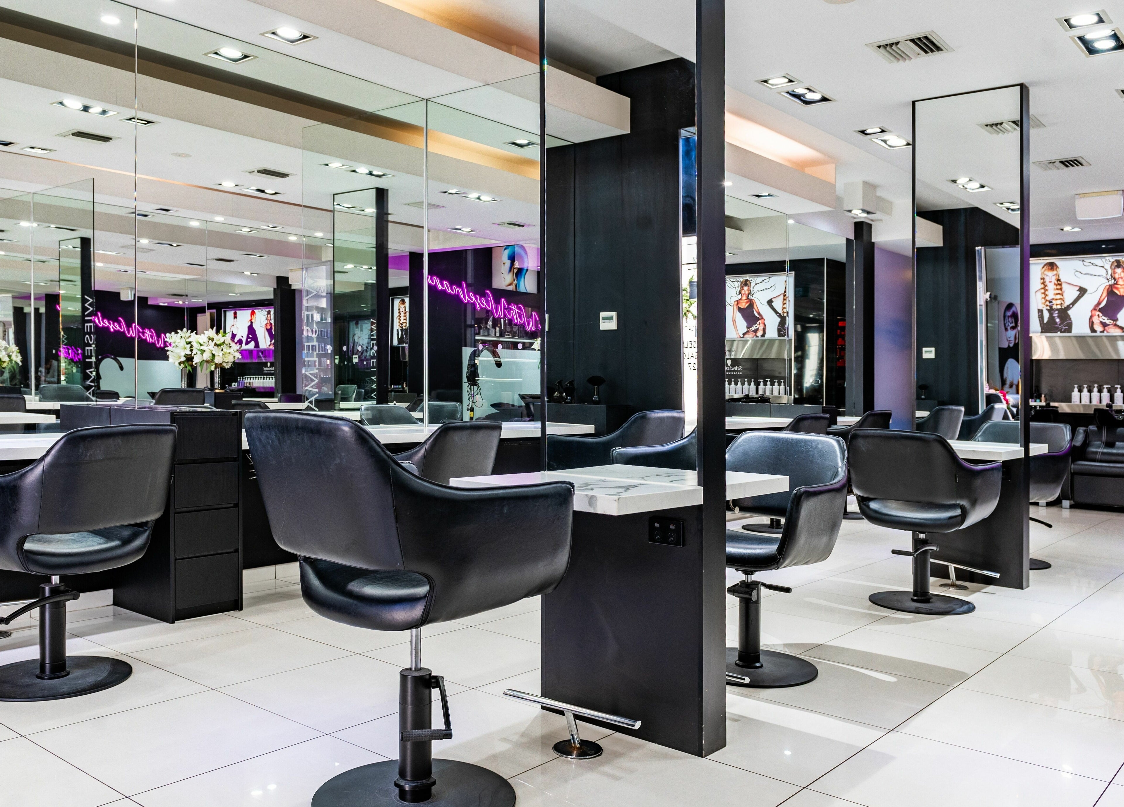 Modern interior of Wieselmann Salon in South Yarra, VIC, AU with plush chairs and well-lit mirrors.