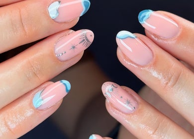 Elegant celestial-themed nail art at The Beauty Shack, Fakenham, England, GB. Perfectly manicured hands featured.