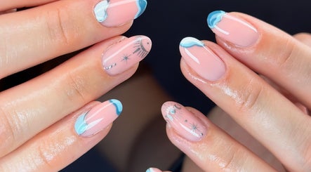 Elegant celestial-themed nail art at The Beauty Shack, Fakenham, England, GB. Perfectly manicured hands featured.