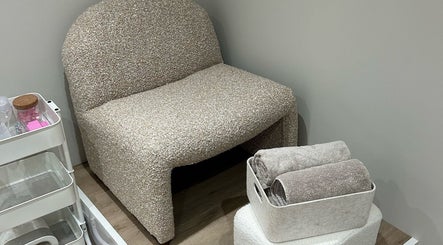 Comfortable seating at MD Nails, Bishop's Stortford, England, GB, with towels ready for use.