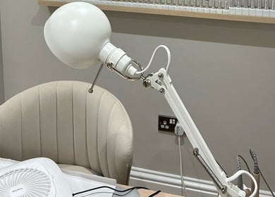 Comfortable nail station at MD Nails, Bishop's Stortford, England, GB featuring a plush chair and lamp.