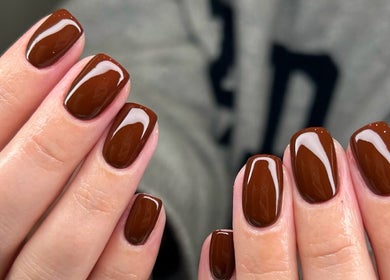 Close-up of glossy, brown manicured nails at MD Nails, Bishop's Stortford, England, GB.
