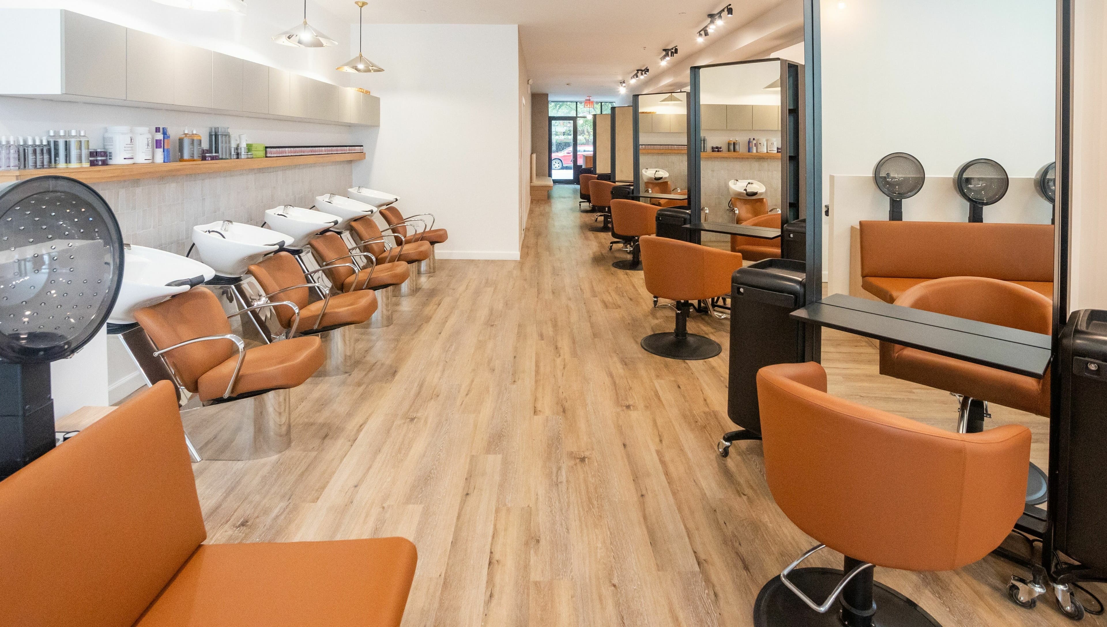 Modern salon layout at TASH BLAQUE, New York, New York, US showcasing elegant styling chairs and stations.