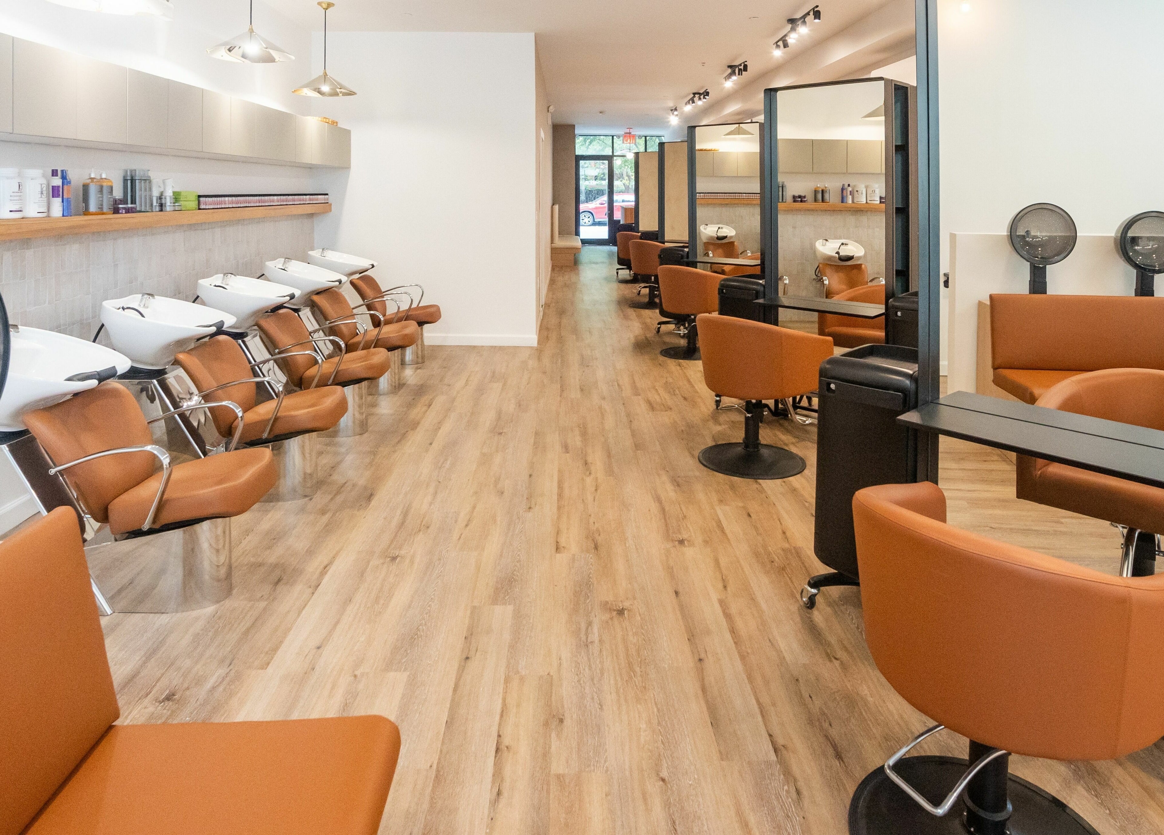 Modern salon layout at TASH BLAQUE, New York, New York, US showcasing elegant styling chairs and stations.