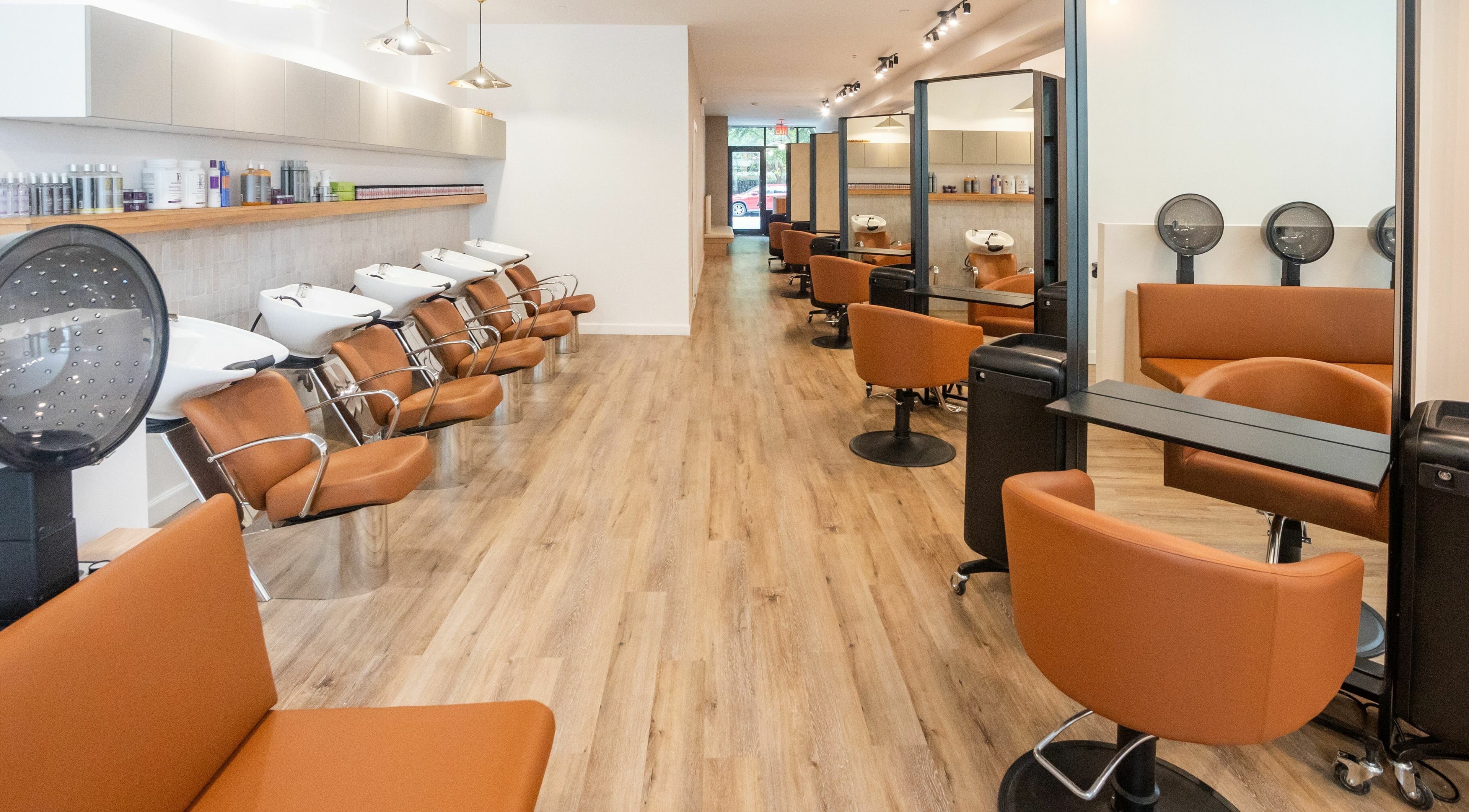 Modern salon layout at TASH BLAQUE, New York, New York, US showcasing elegant styling chairs and stations.