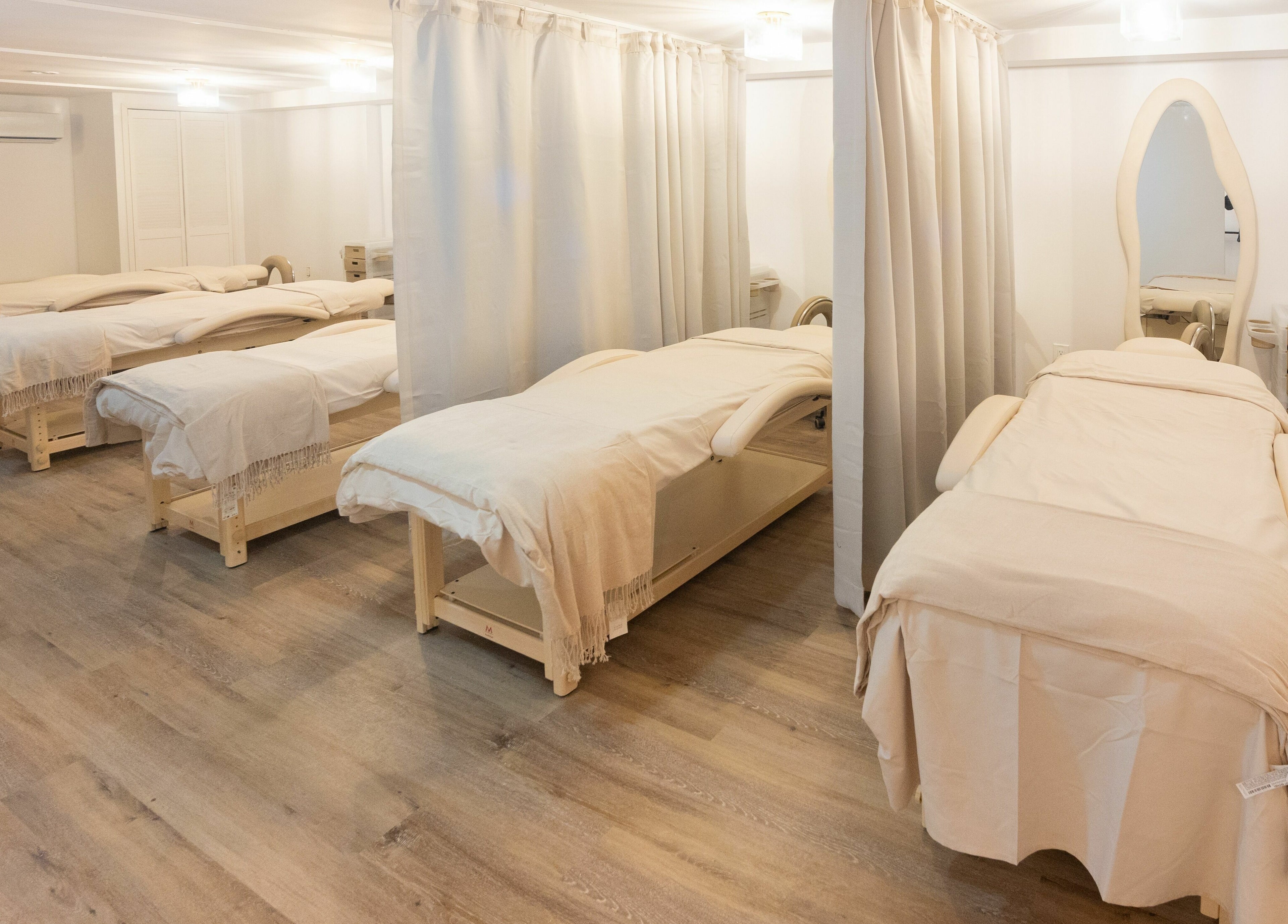 Tranquil treatment room at TASH BLAQUE, New York, New York, US, featuring plush massage tables.
