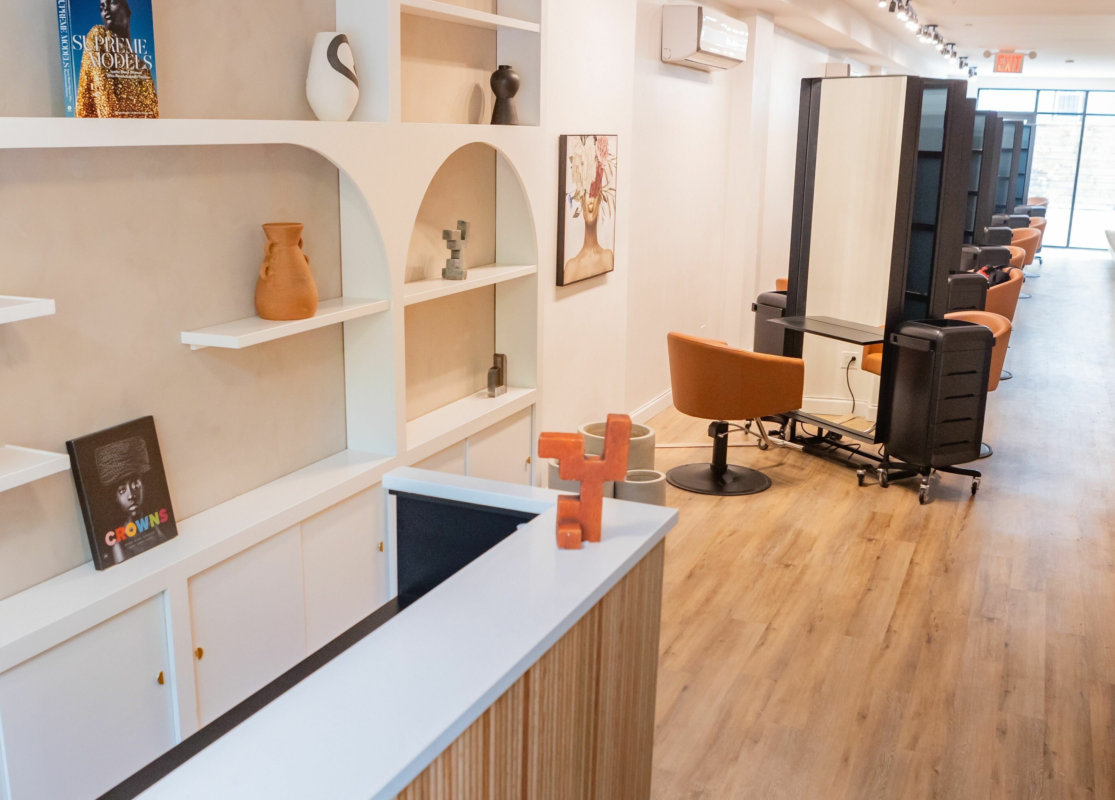 Elegant interior of TASH BLAQUE salon in New York, New York, US, showcasing modern design and styling stations.