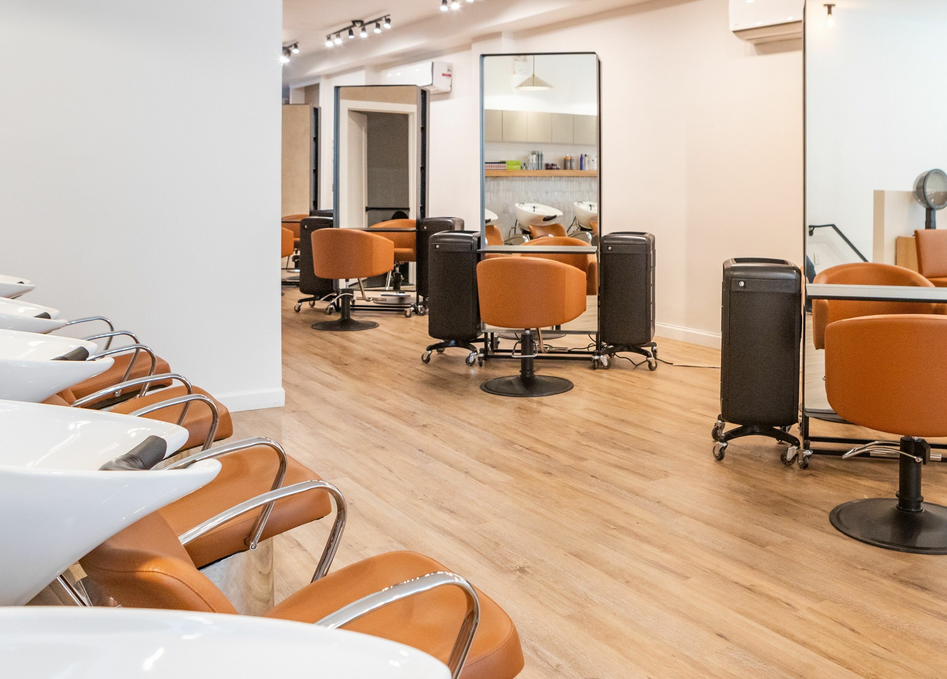Sophisticated salon interior at TASH BLAQUE, New York, New York, US, featuring stylish chairs and mirrors.