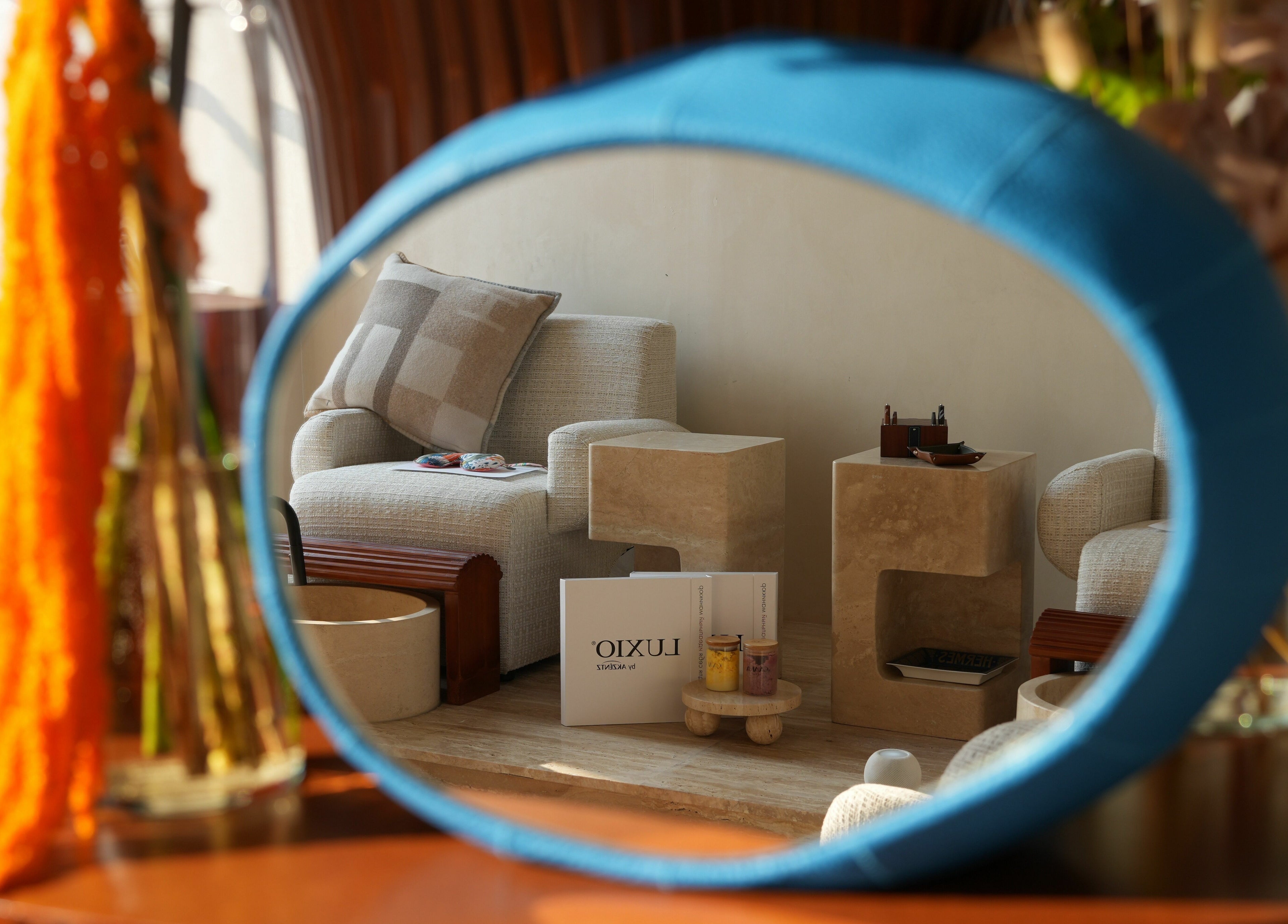 Cozy seating and decor reflected in a mirror at GAARA SPA, Doha, Doha Municipality, QA.