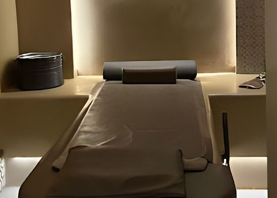 Relaxing spa treatment room at Sultana Spa LLC, Dubai, AE, with a comfortable massage table and soothing lighting.