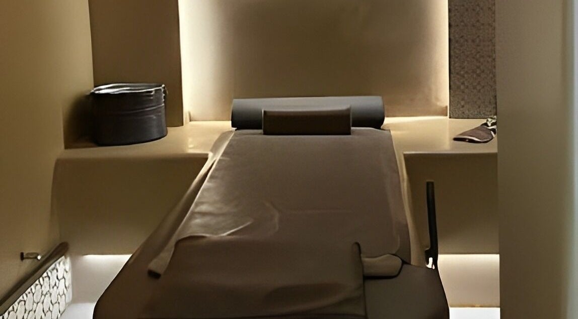 Relaxing spa treatment room at Sultana Spa LLC, Dubai, AE, with a comfortable massage table and soothing lighting.