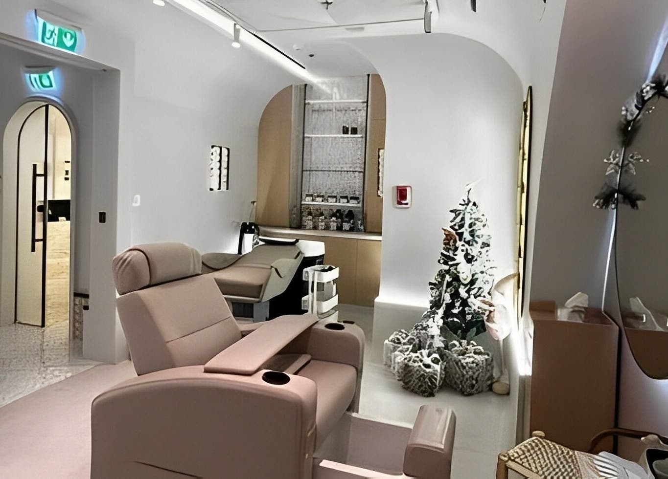 Relaxing treatment room at Sultana Spa LLC, Dubai, AE, featuring plush seating and chic decor.