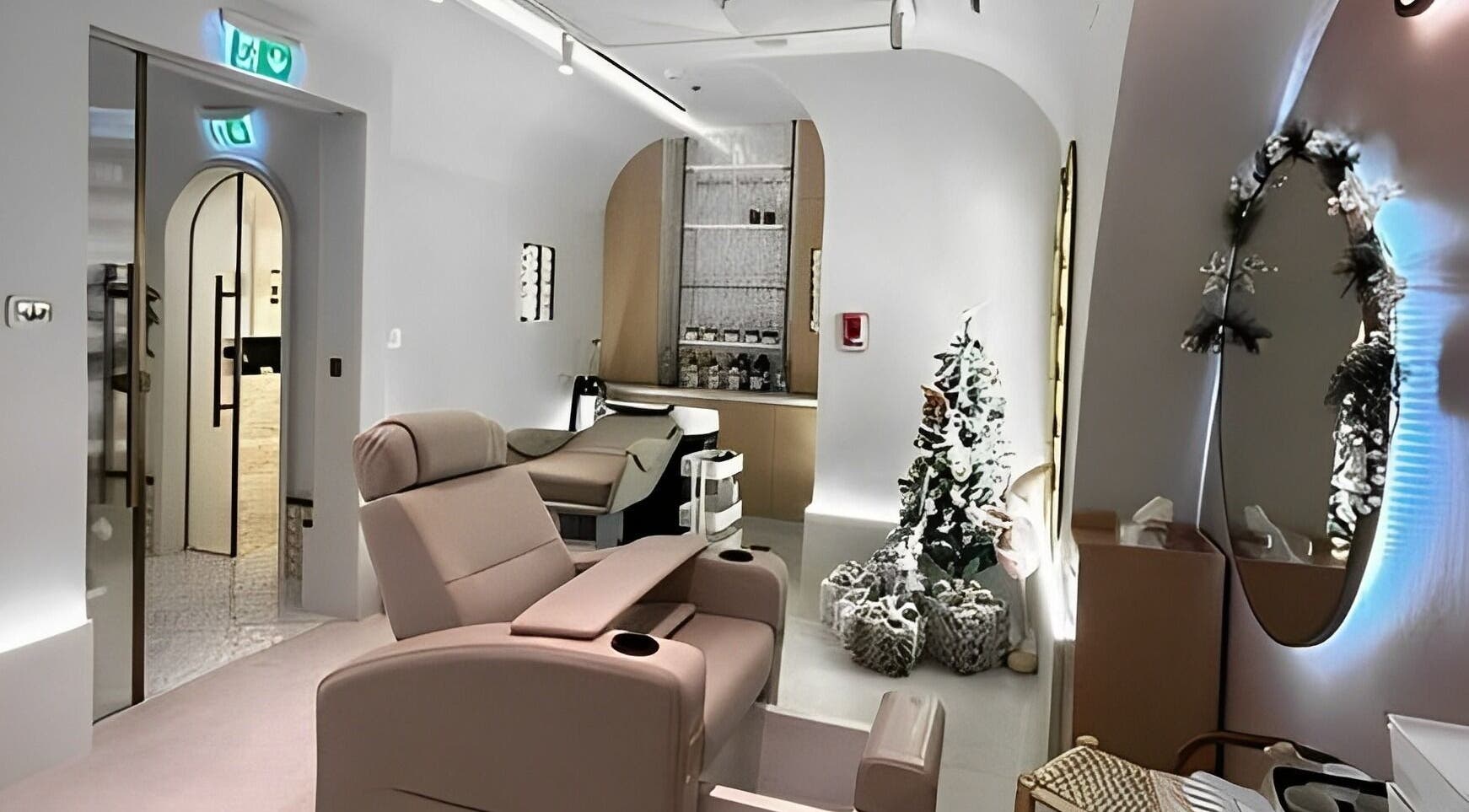Relaxing treatment room at Sultana Spa LLC, Dubai, AE, featuring plush seating and chic decor.