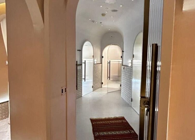 Elegant hallway in Sultana Spa LLC, Dubai, AE, featuring arches and soft lighting for a tranquil ambiance.