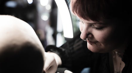 Professional piercer at work at Pin Cushion Piercing, Buckland, Waikato, NZ, showcasing precision and skill.