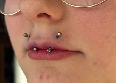 Close-up of stylish lip and nose piercings at Pin Cushion Piercing in Buckland, Waikato, NZ.