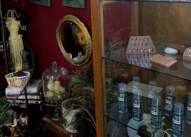 Eclectic decor and jewelry at Pin Cushion Piercing in Buckland, Waikato, NZ with a mirror and shelves.