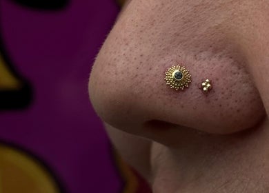 Close-up of a decorative nose piercing at Pin Cushion Piercing, Buckland, Waikato, NZ.