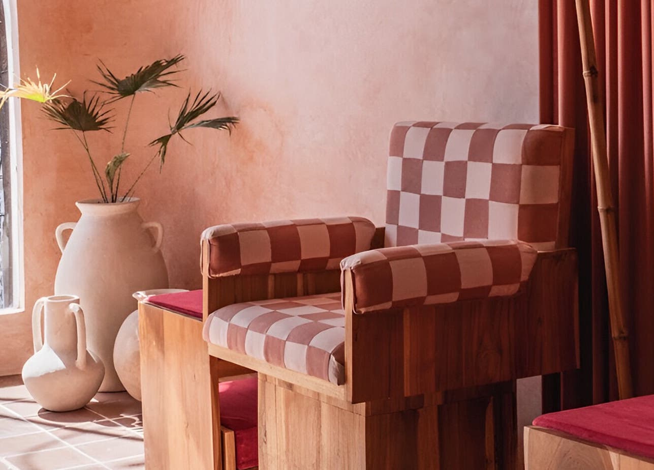 Chic seating at Rosie's Nail Bar - Canggu, Badung, Indonesia, ID with checkered chair and pottery decor.